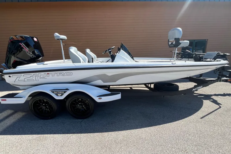 Slide: The Image of 2027 Nitro Z21 XL Pro boat on trailer, side view, in sunlight. - 1