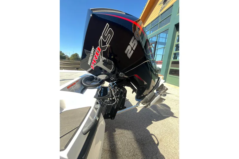 Slide: The Image of 2027 Nitro Z21 XL Pro with Mercury Pro XS 250 outboard motor, parked outdoors. - 13