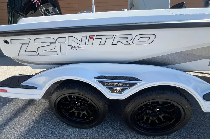 Slide: The Image of 2027 Nitro Z21 XL Pro boat on trailer with black wheels. - 10
