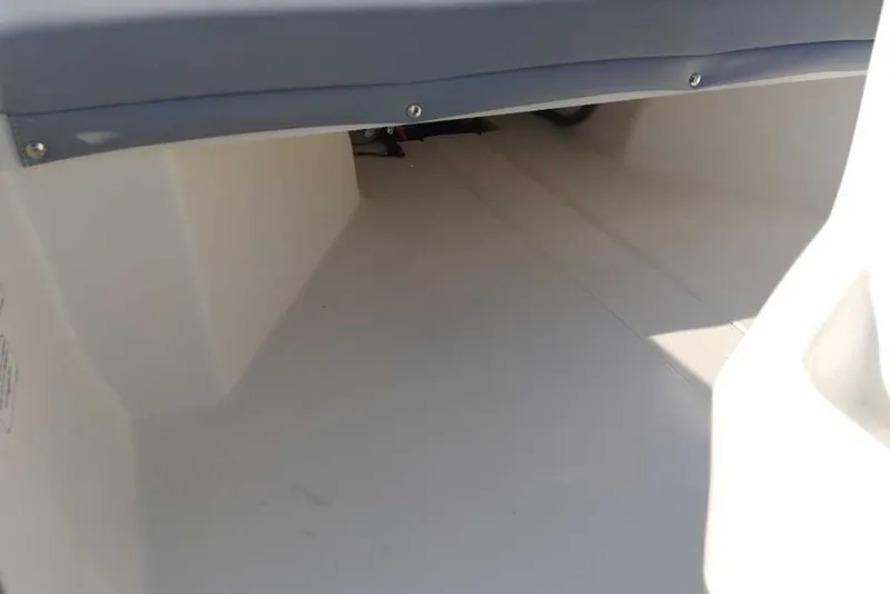 Slide: The Image of Interior view of a 2026 Mako Pro Skiff 13 CC boat, showcasing spacious storage area. - 9