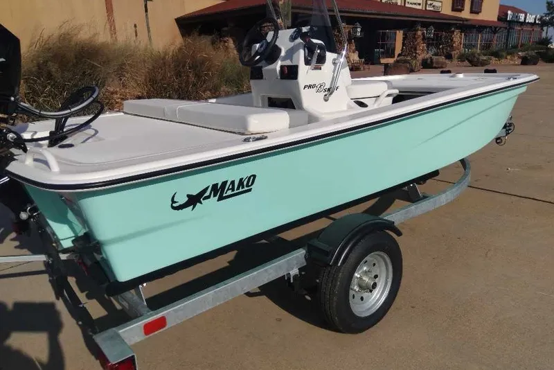 Slide: The Image of 2026 Mako Pro Skiff 13 CC boat on trailer, light blue hull, outdoor setting. - 3