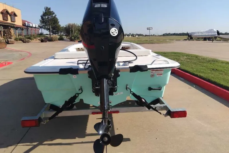 Slide: The Image of 2026 Mako Pro Skiff 13 CC boat on trailer, rear view with outboard motor. - 10