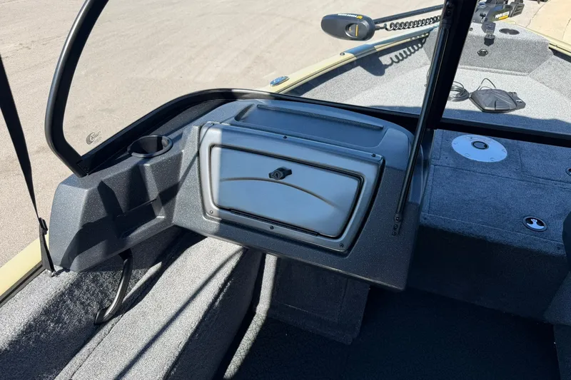 Slide: The Image of 2027 Tracker Pro Guide V-16 WT boat interior with storage compartment and cup holder. - 13