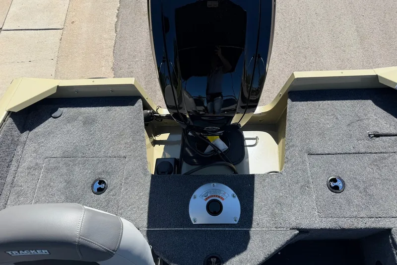 Slide: The Image of 2027 Tracker Pro Guide V-16 WT boat interior with motor and seating area. - 18