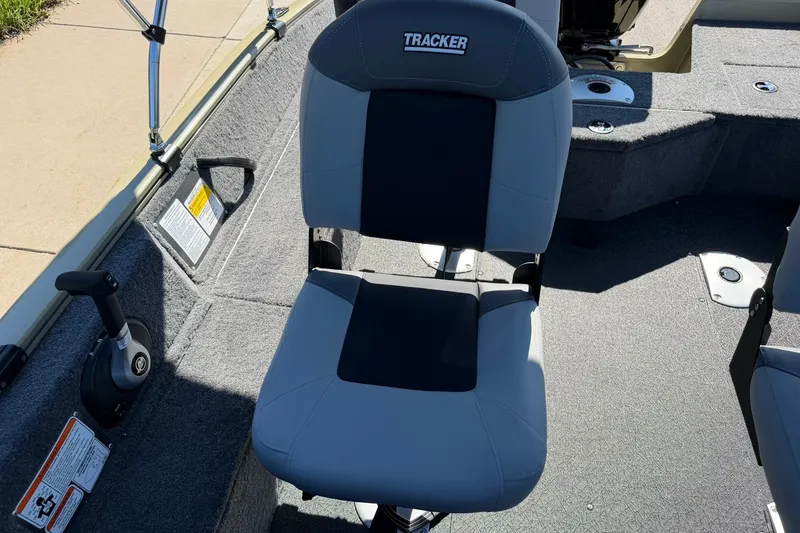 Slide: The Image of 2027 Tracker Pro Guide V-16 WT boat seat, gray and black upholstery, interior view. - 16
