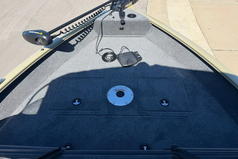 Slide: The Image of 2027 Tracker Pro Guide V-16 WT boat deck with trolling motor and storage compartments. - 19