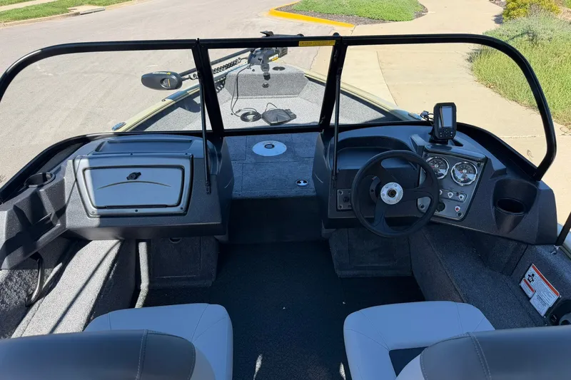 Slide: The Image of 2027 Tracker Pro Guide V-16 WT boat interior with steering wheel and dashboard controls. - 14