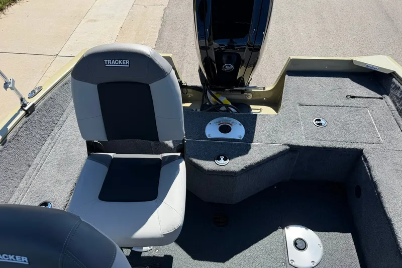 Slide: The Image of 2027 Tracker Pro Guide V-16 WT boat interior with seating and motor. - 17