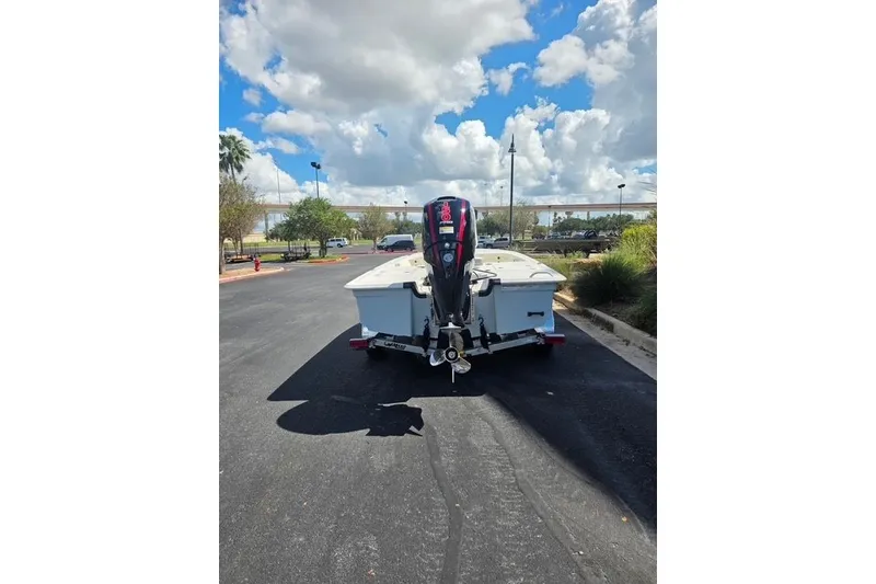 Slide: The Image of 2026 Mako 18 Pro Skiff boat on trailer, parked outdoors under a cloudy sky. - 4