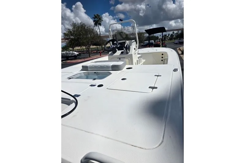 Slide: The Image of 2026 Mako 18 Pro Skiff boat with sleek white deck and steering console. - 12