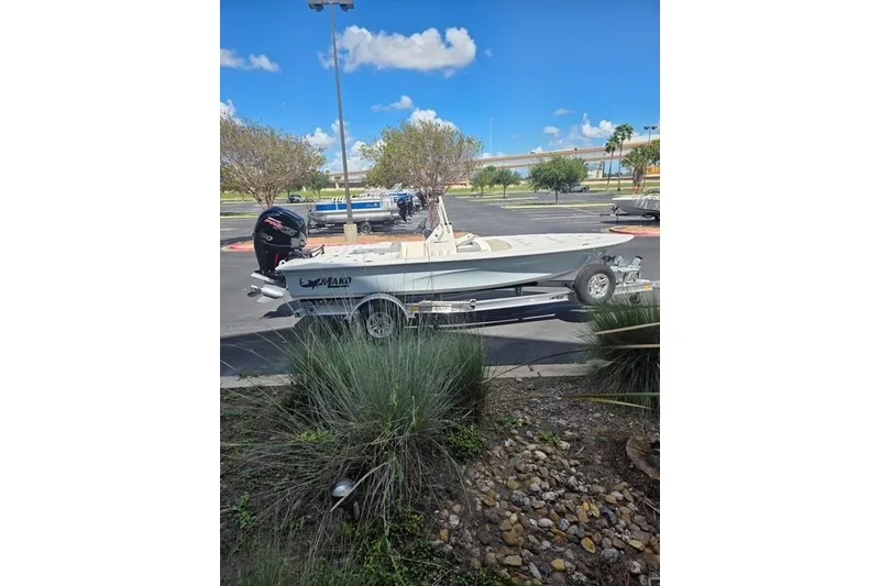 Slide: The Image of 2026 Mako 18 Pro Skiff boat on trailer in parking lot, sunny day. - 3