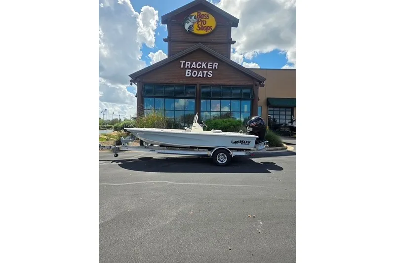 Slide: The Image of 2026 Mako 18 Pro Skiff boat on trailer outside Tracker Boats store. - 9