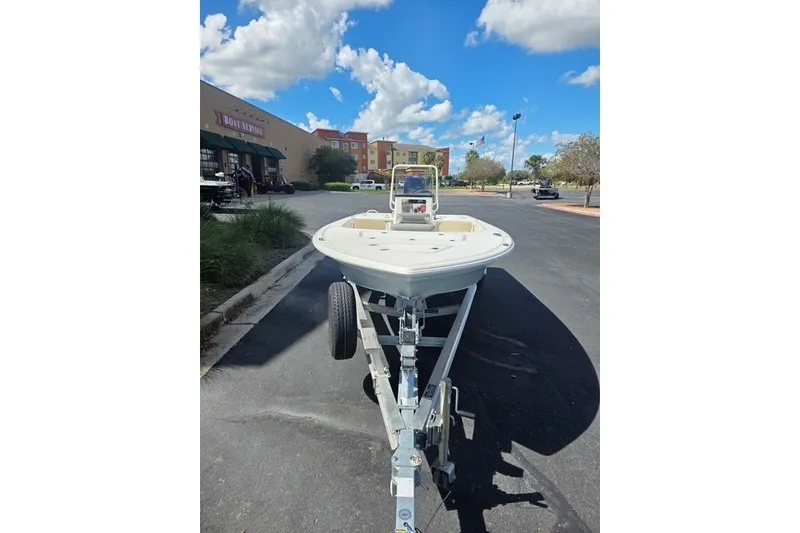 Slide: The Image of 2026 Mako 18 Pro Skiff on trailer in parking lot under blue sky. - 10
