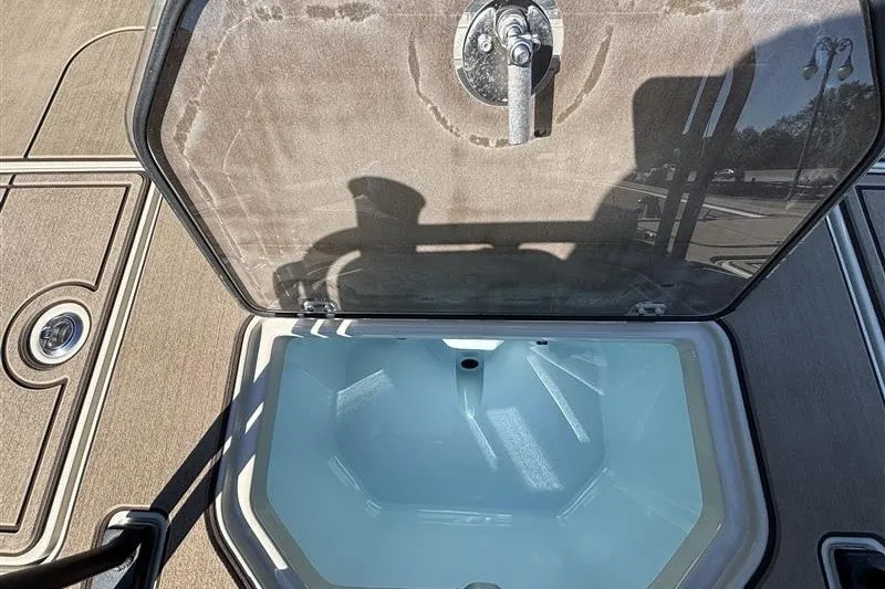 Slide: The Image of Open storage compartment on 2025 Mako 18 Pro Skiff Backwater Edition boat. - 31