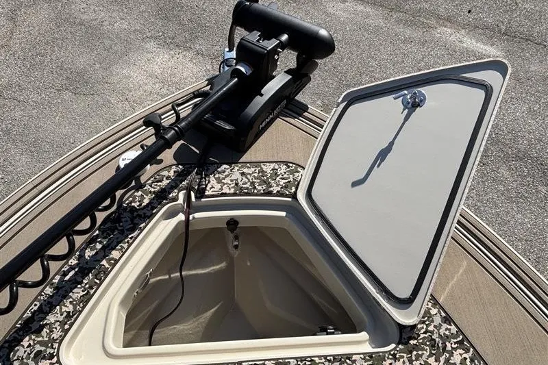 Slide: The Image of 2025 Mako 18 Pro Skiff Backwater Edition with open storage compartment and trolling motor. - 19