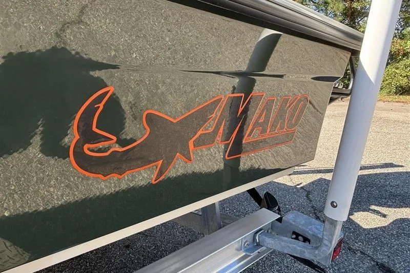Slide: The Image of 2025 Mako 18 Pro Skiff Backwater Edition logo on boat hull in sunlight. - 33