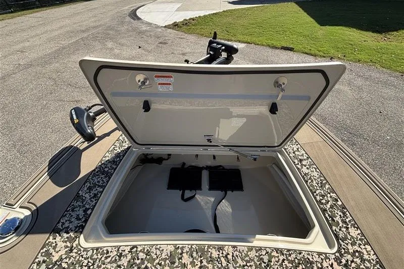 Slide: The Image of 2025 Mako 18 Pro Skiff Backwater Edition boat storage compartment open, showing interior details. - 20