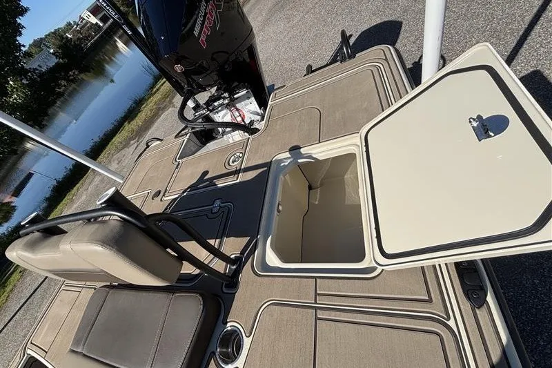 Slide: The Image of 2025 Mako 18 Pro Skiff Backwater Edition boat deck with storage compartment open. - 26