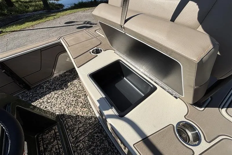 Slide: The Image of 2025 Mako 18 Pro Skiff Backwater Edition boat interior with storage compartment open. - 27