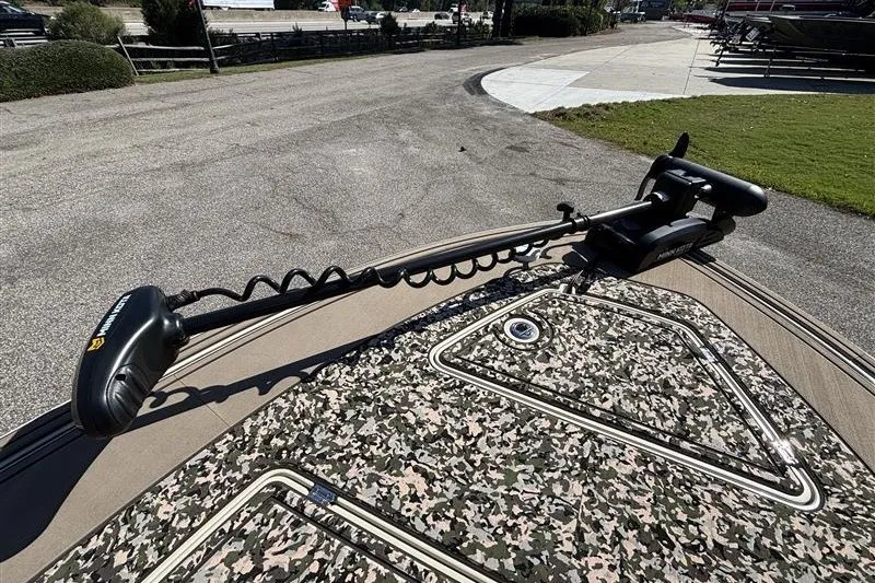 Slide: The Image of 2025 Mako 18 Pro Skiff Backwater Edition with camo deck and trolling motor. - 13
