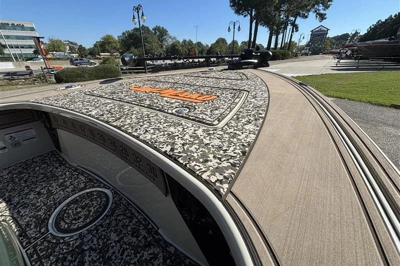 Slide: The Image of 2025 Mako 18 Pro Skiff Backwater Edition with camouflage deck, parked outdoors. - 21