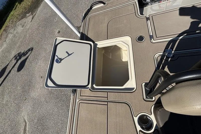 Slide: The Image of 2025 Mako 18 Pro Skiff Backwater Edition boat deck with open storage compartment. - 29