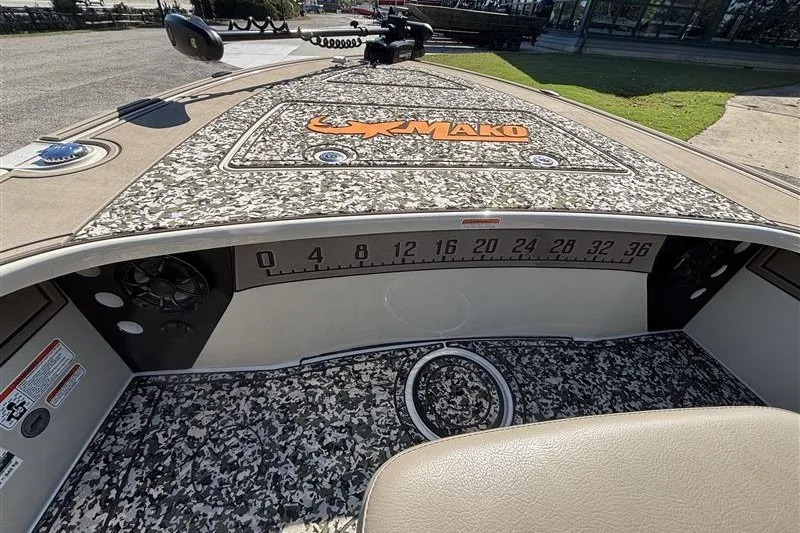 Slide: The Image of 2025 Mako 18 Pro Skiff Backwater Edition boat interior with camo design and measurement scale. - 15