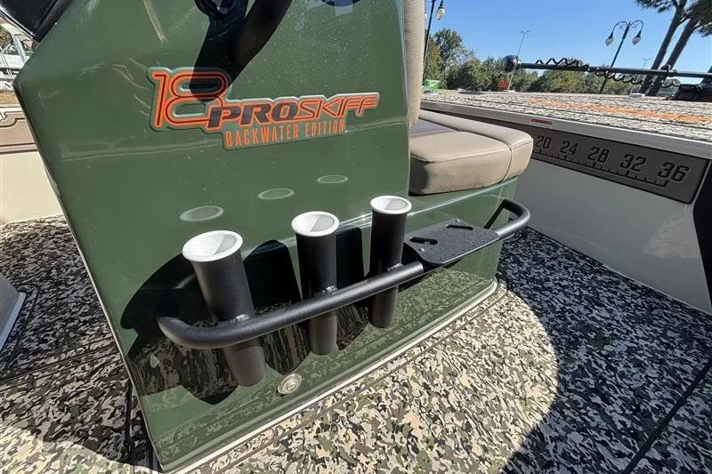 Slide: The Image of 2025 Mako 18 Pro Skiff Backwater Edition boat interior with rod holders and seating. - 23
