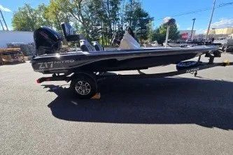 Slide: The Image of 2027 Nitro Z17 boat on trailer, parked outdoors, side view. - 7
