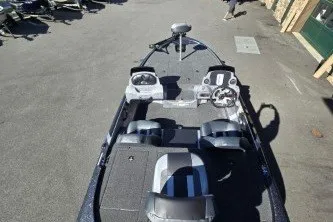 Slide: The Image of 2027 Nitro Z17 fishing boat with dual seats and steering console, parked on pavement. - 2