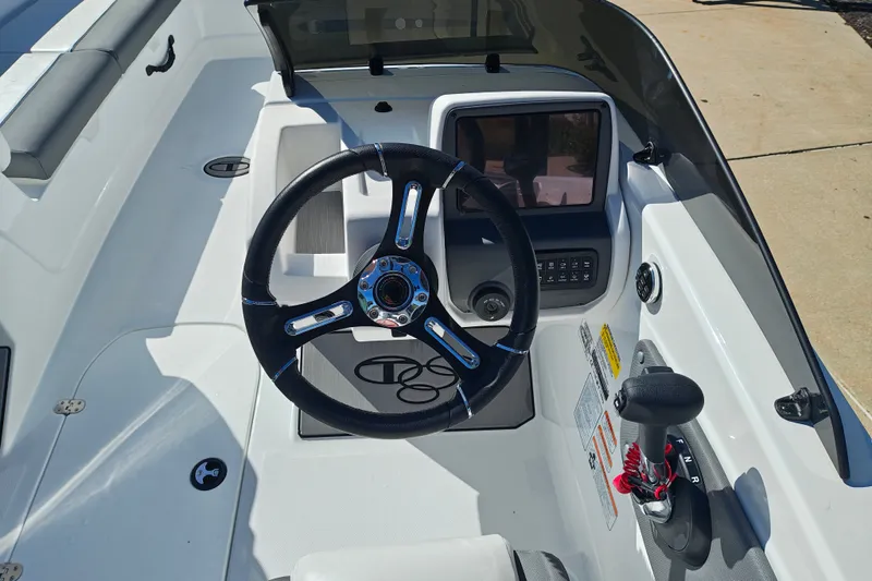 Slide: The Image of Steering console of a 2027 Tahoe T21 boat, featuring modern controls and sleek design. - 14