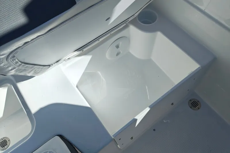Slide: The Image of Open storage compartment in 2027 Tahoe T21 boat, featuring a clean, white interior design. - 41