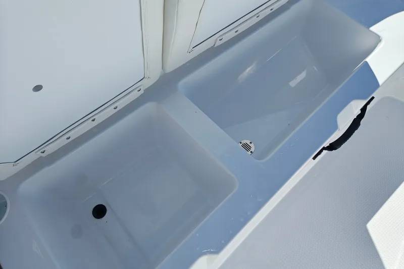Slide: The Image of Interior compartments of a 2027 Tahoe T21 boat, featuring storage and drainage. - 30