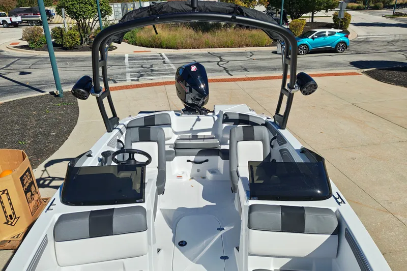 Slide: The Image of 2027 Tahoe T21 boat with sleek interior design and modern features, parked outdoors. - 33