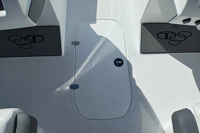 Slide: The Image of 2027 Tahoe T21 boat interior with storage hatch and branded mats. - 24