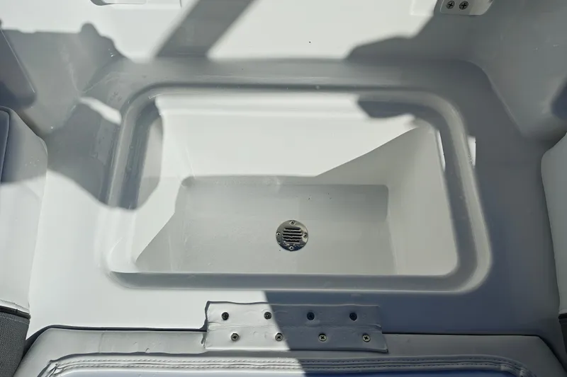 Slide: The Image of 2027 Tahoe T21 boat storage compartment with drain, featuring a sleek white interior design. - 42
