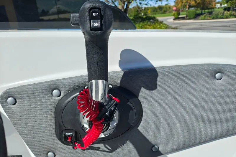 Slide: The Image of Throttle control lever on a 2027 Tahoe T21 boat, featuring up and down buttons. - 18