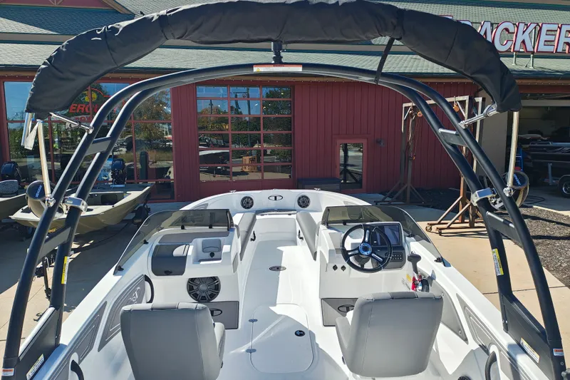 Slide: The Image of 2027 Tahoe T21 boat interior with steering wheel and seating, displayed outdoors. - 9