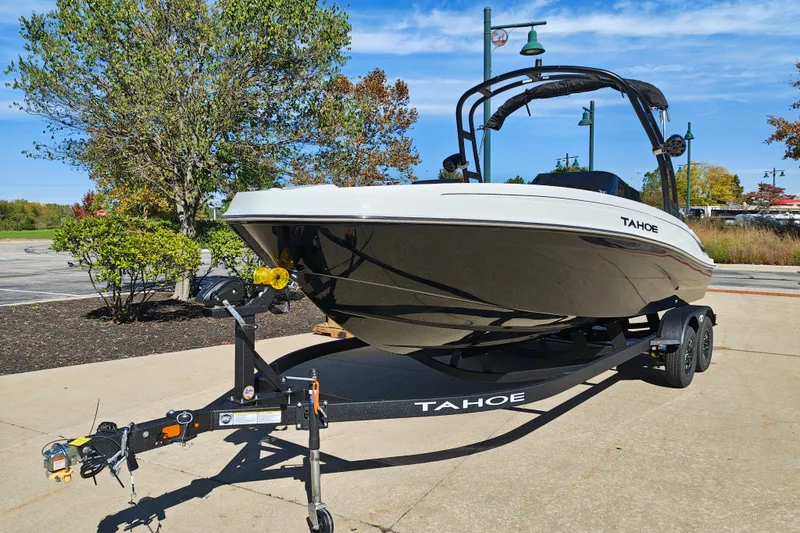 Slide: The Image of 2027 Tahoe T21 boat on trailer in sunny outdoor setting. - 4