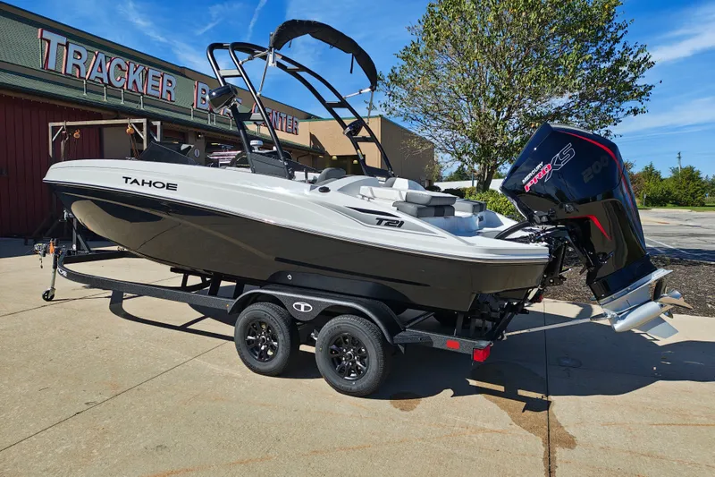 Slide: The Image of 2027 Tahoe T21 boat with powerful Mercury engine on trailer at dealership. - 1