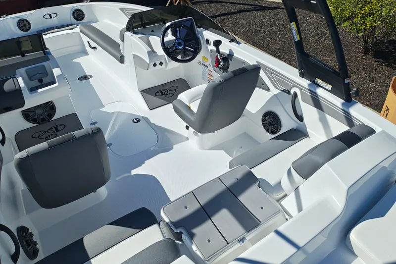 Slide: The Image of 2027 Tahoe T21 boat interior with modern seating and steering wheel design. - 11