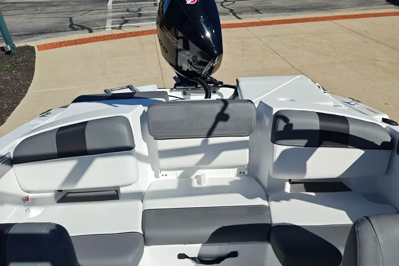 Slide: The Image of 2027 Tahoe T21 boat interior with gray seating and outboard motor. - 40