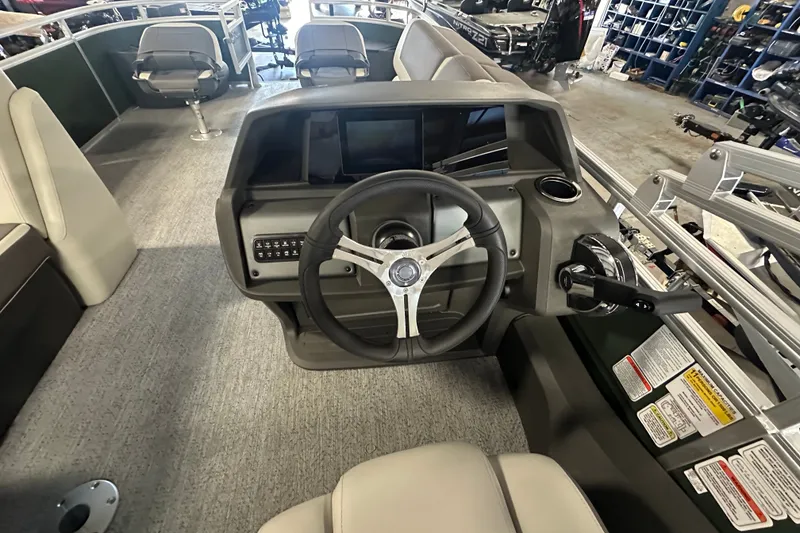 Slide: The Image of Interior view of a 2027 Sun Tracker Fishin' Barge 22 DLX boat dashboard. - 12