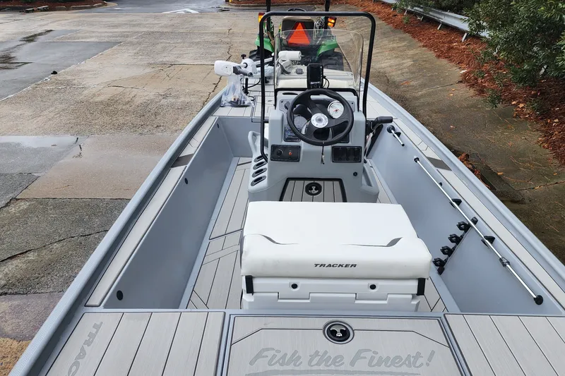 Slide: The Image of 2027 Tracker Bass Tracker Classic CC boat interior with steering console and seating. - 64