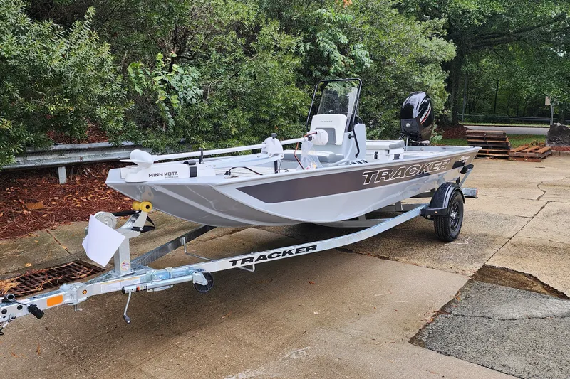 Slide: The Image of 2027 Tracker Bass Tracker Classic CC boat on trailer, parked outdoors. - 57