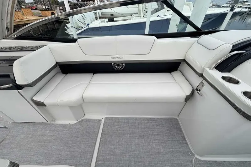 Slide: The Image of 2023 Formula 310 Bowrider I/O interior with white seating and modern design. - 11