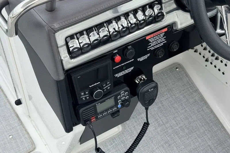Slide: The Image of 2023 Formula 310 Bowrider I/O dashboard with control panel and communication devices. - 23