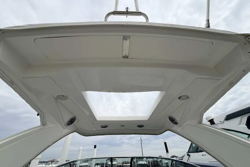 Slide: The Image of 2023 Formula 310 Bowrider I/O boat roof with speakers and open sky view. - 6