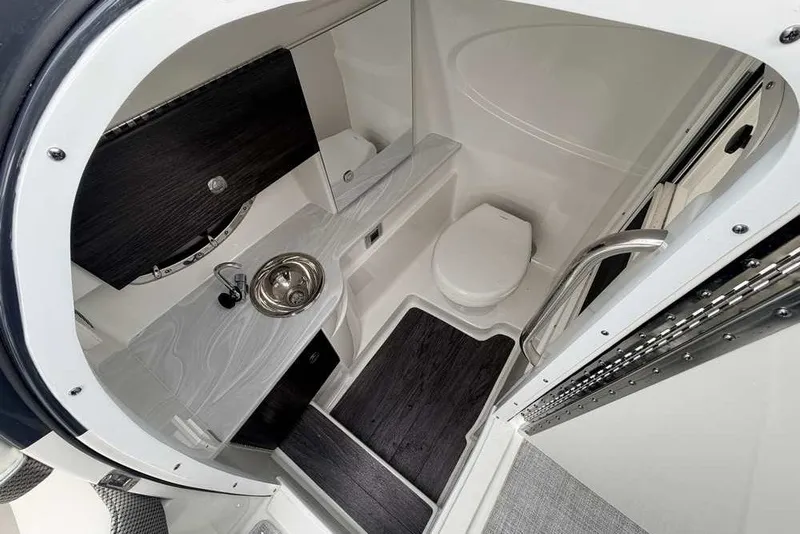 Slide: The Image of 2023 Formula 310 Bowrider I/O boat interior with compact bathroom and sink. - 13