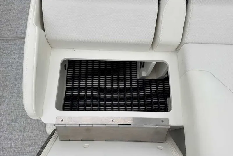 Slide: The Image of 2023 Formula 310 Bowrider I/O storage compartment with white cushioned seating. - 16